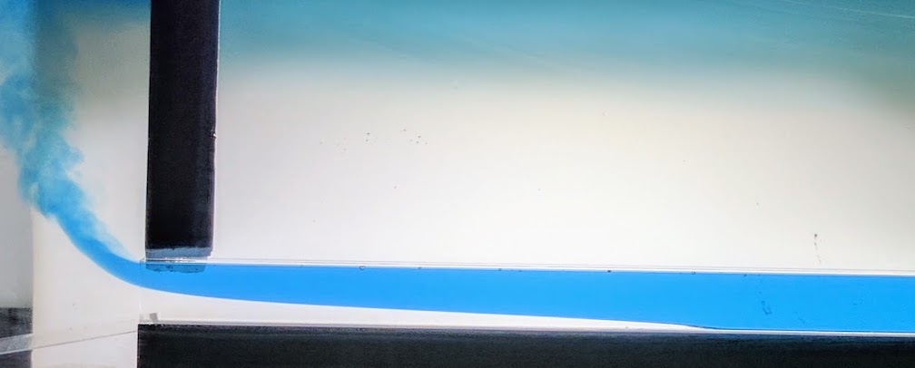 Water with dye is used to illustrate seawater seep under glaciers.