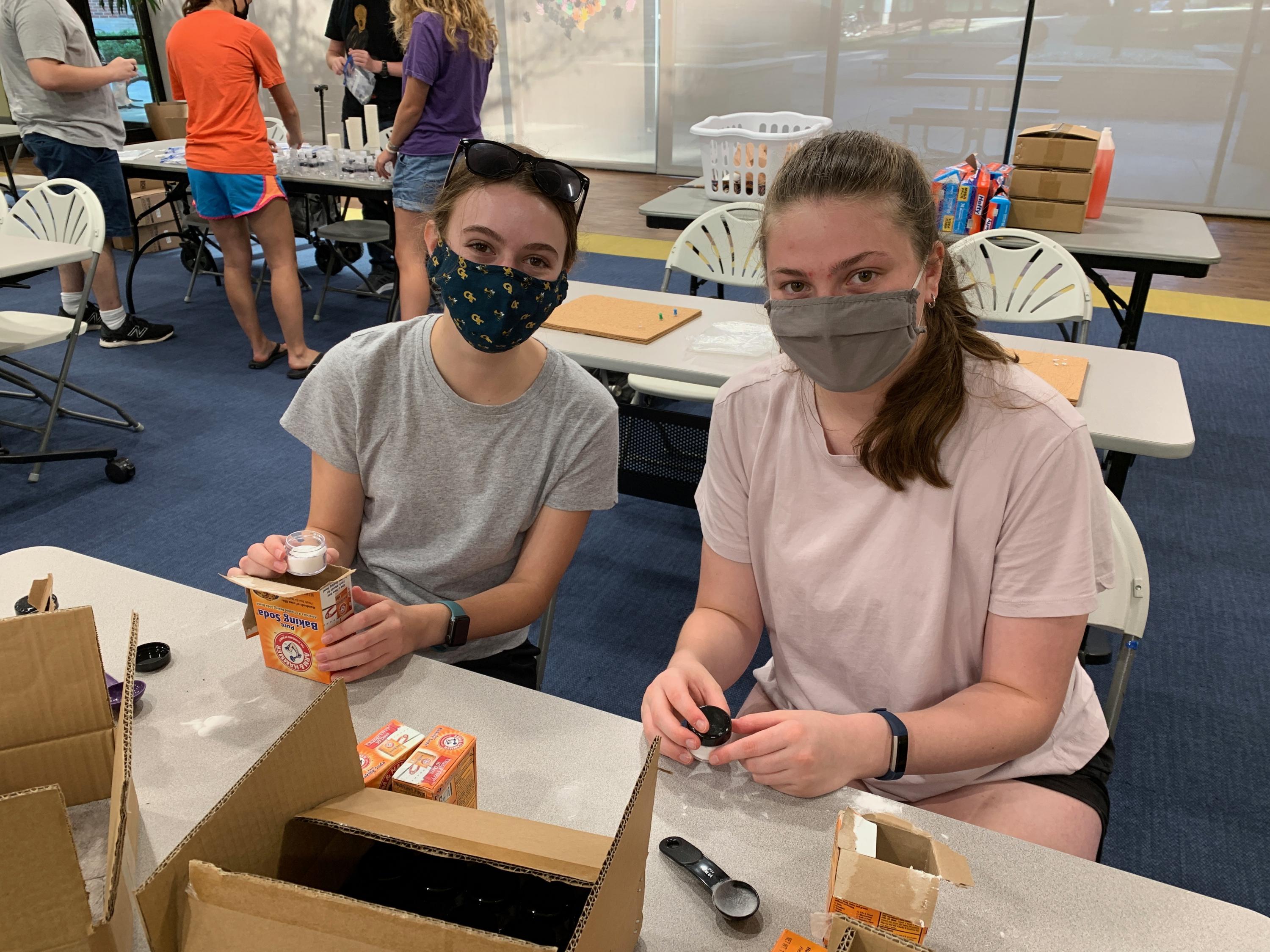 Little Einstein Organization volunteers Paige Holland (left) and Grace May prepare at-home science kits for Atlanta K-5 students. (Photo: Olivia Gravina)