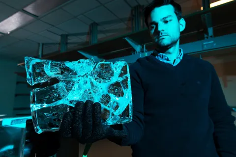 Alexander Robel holds ice used in glacial melt research. 