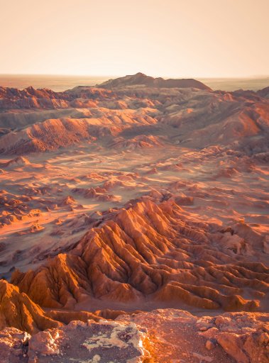 A landscape of red mountains and valleys in the arid Atacama Desert.